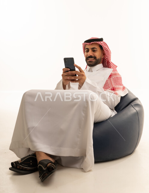 Saudi Man Using Smartphone on Bean Bag Studio