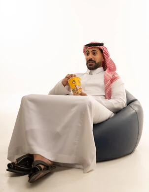 Saudi Man with Popcorn Expressing Surprise