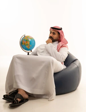 Saudi Man in Thobe Holding Globe on White Background
