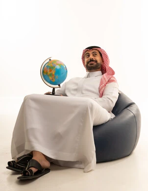 Saudi Man in Traditional Dress Holding Globe in Studio