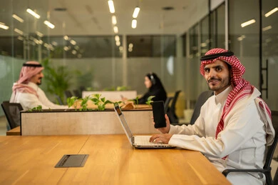 Management and division of tasks, a Saudi Gulf Arab team using advanced technical devices, integrating modern technologies into office work, developing projects and investments.