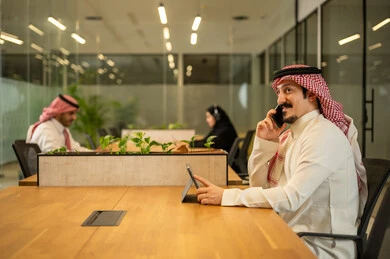 Management and division of tasks, a Saudi Gulf Arab team using advanced technical devices, integrating modern technologies into office work, developing projects and investments. Management and division of tasks, a Saudi Gulf Arab team using advanced technical devices, integrating modern technologies into office work, developing projects and investments.