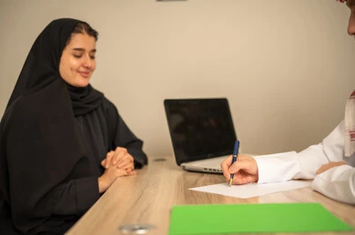 Study of working papers, project and investment development, use of laptops, two Arab Gulf Saudi employees conducting a business meeting inside the office, integrating modern technological devices with office work, managing and dividing tasks. Study of working papers, project and investment development, use of laptops, two Arab Gulf Saudi employees conducting a business meeting inside the office, integrating modern technological devices with office work, managing and dividing tasks.