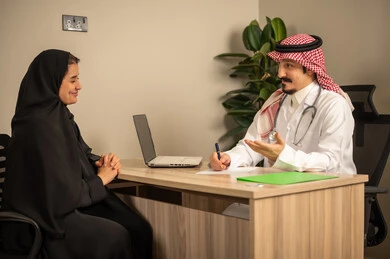 Study of working papers, project and investment development, use of laptops, two Arab Gulf Saudi employees conducting a business meeting inside the office, integrating modern technological devices with office work, managing and dividing tasks. Study of working papers, project and investment development, use of laptops, two Arab Gulf Saudi employees conducting a business meeting inside the office, integrating modern technological devices with office work, managing and dividing tasks.