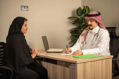 Study of working papers, project and investment development, use of laptops, two Arab Gulf Saudi employees conducting a business meeting inside the office, integrating modern technological devices with office work, managing and dividing tasks. Study of working papers, project and investment development, use of laptops, two Arab Gulf Saudi employees conducting a business meeting inside the office, integrating modern technological devices with office work, managing and dividing tasks.