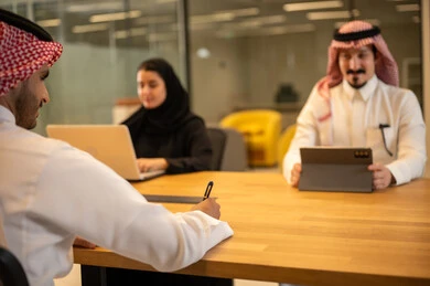 Saudi professions and jobs, integrating work with advanced technology, Arab Gulf Saudi employees using modern technical devices, accomplishing work tasks, achieving company goals, the Saudi work environment.