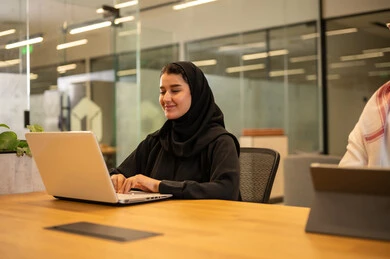 Saudi Arabian Gulf employees use modern technology to accomplish work tasks. Saudi Arabian jobs and professions, achieving company goals, Saudi work environment.