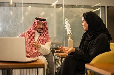 Arab Gulf Saudi employees use modern technological devices, Saudi professions and jobs, achieving the company's goals, discussing and explaining remote work tasks, completing work tasks, the Saudi work environment.