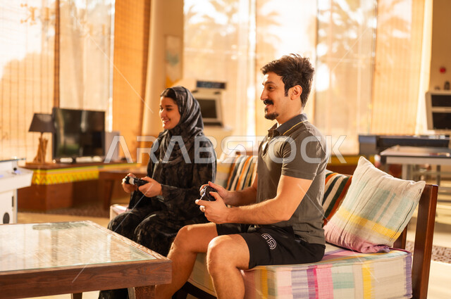 Saudi Couple Playing Video Games in Modern Indoor Setting