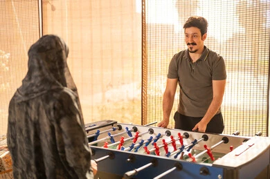 Saudi Couple Playing Foosball Table Indoors
