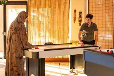 Saudi Couple Playing Air Hockey in Game Room