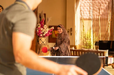 Arab Woman Playing Table Tennis in Traditional Abaya