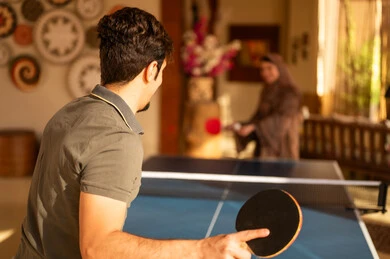 Saudi Man and Woman Playing Indoor Table Tennis