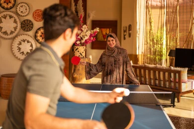 Arab Couple Playing Table Tennis Indoors