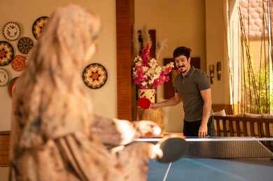 Saudi Couple Playing Table Tennis Indoors