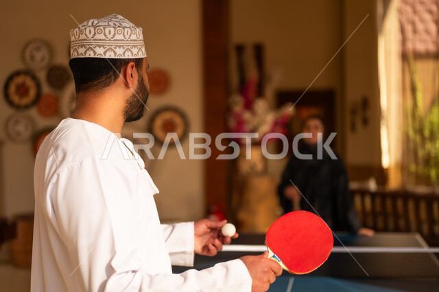 Omani Man Playing Table Tennis in Traditional Dress