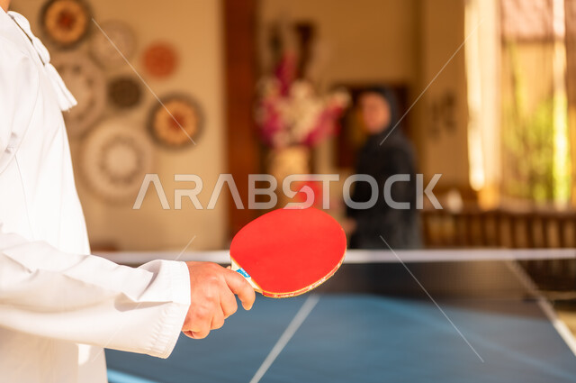 Saudi Man in Traditional Thobe Playing Table Tennis Indoor