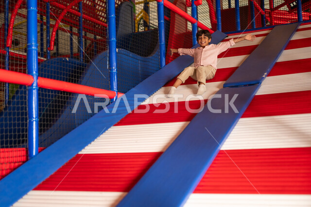 Saudi Boy Sliding at Indoor Playground Play Area