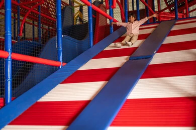 Saudi Boy Sliding at Indoor Amusement Center