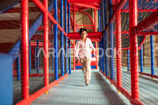 Arab Boy Running in Indoor Playground Area