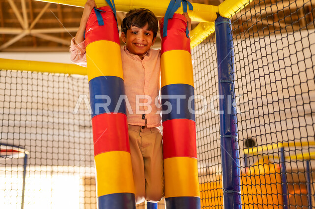 Saudi Boy Playing in Indoor Recreational Playground
