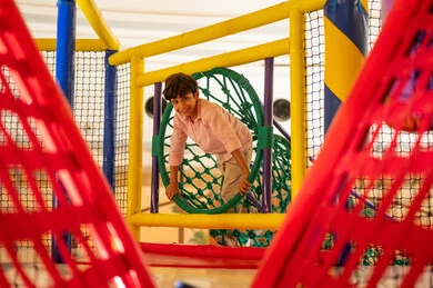 Arab Boy Playing in Colorful Indoor Playground
