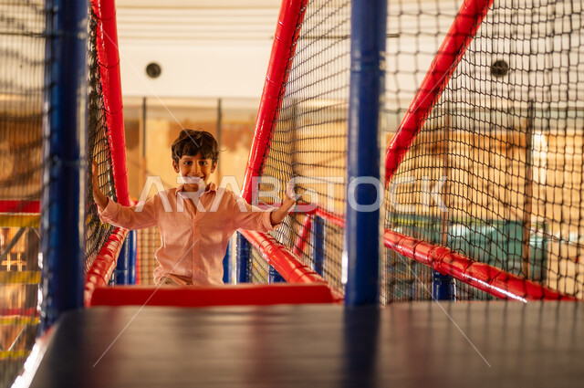 Young Saudi Boy Playing in Indoor Soft Playground