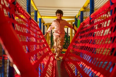 Arab Boy Balancing in Indoor Children Playground