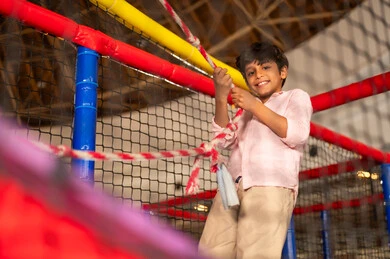 Saudi Boy Smiling at Indoor Playground