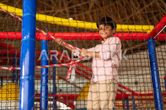 Saudi Boy Playing in Indoor Playground Center