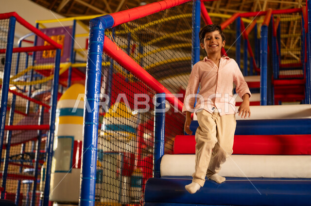 Saudi Boy Playing in Indoor Playground Center