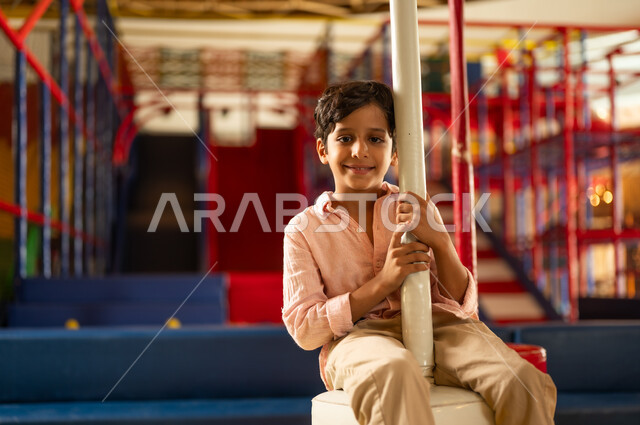 Saudi Boy Smiling in Indoor Playground Setting