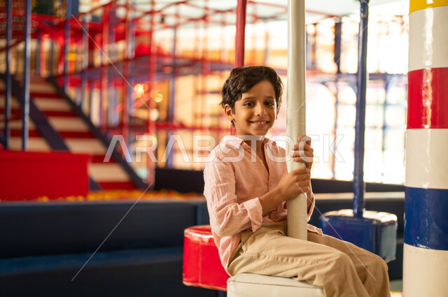 Saudi Boy Smiling at Indoor Children Playground