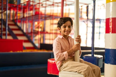 Saudi Boy Smiling at Indoor Children Playground
