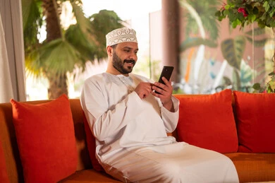 Omani Man Using Smartphone in Traditional Clothing