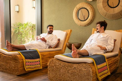 Arab Men Relaxing in Spa Wearing White Robes