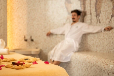 Arab Man in White Bathrobe Relaxing in Luxury Spa