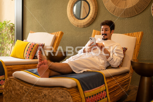 Saudi Man Using Smartphone in Luxury Spa