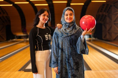 Arab Women Holding Bowling Ball in Alley Arab Women Holding Bowling Ball in Alley