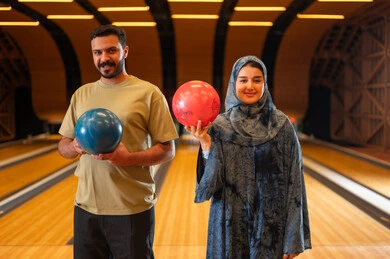 Saudi Man and Woman in Modern Bowling Alley