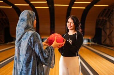 Arab Women Playing Bowling in Indoor Sports Center