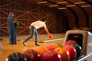 Saudi Couple Playing Bowling in Modern Indoor Center