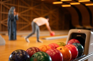 Saudi Man and Woman Playing Bowling in Leisure Center
