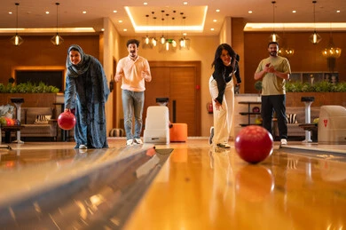 Saudi Youth Playing Bowling in Modern Indoor Center