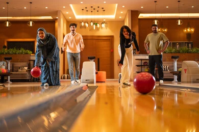 Arab Friends Playing Bowling in Indoor Entertainment Center