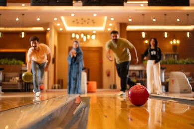 Saudi Men Bowling in Modern Indoor Entertainment Center