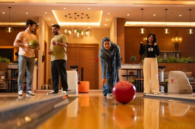 Arab Friends Playing Bowling in Modern Indoor Alley
