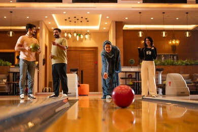 Arab Friends Playing Bowling at Indoor Entertainment Center