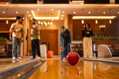 Saudi Woman Playing Bowling in Indoor Recreation Center