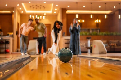 Saudi Friends Playing Bowling at Indoor Entertainment Center